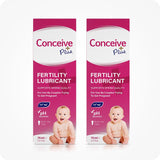 Image of two boxes of Conceive Plus fertility lubricant tube 75ml placed side by side on a white background. Pink boxes with white branding and text have highlights about sperm quality support, pH balance, Calcium and Magnesium ions, multi-use feature, and quantity of the lube. Boxes also feature a smiling baby.